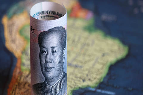 A stock photo of the Chinese yuan on a map of South America.