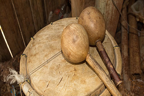 A stock photo of a garifuna drum and a set of maracas.