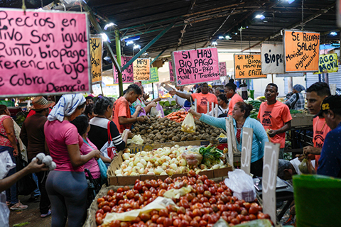 A market in Venezuela with people exchanging goods and products. 